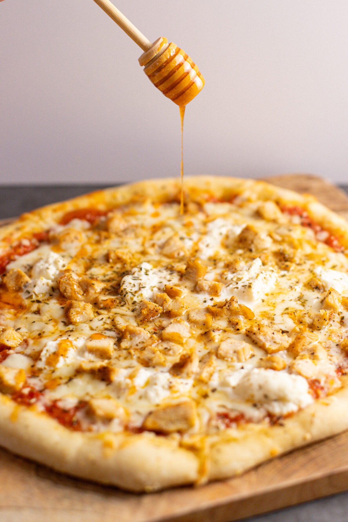 hot honey drizzled onto chicken pizza