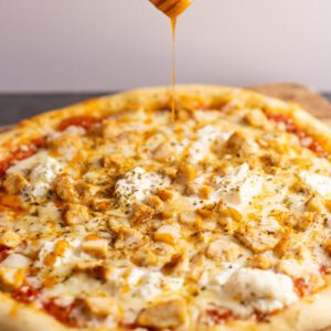 hot honey drizzled onto chicken pizza