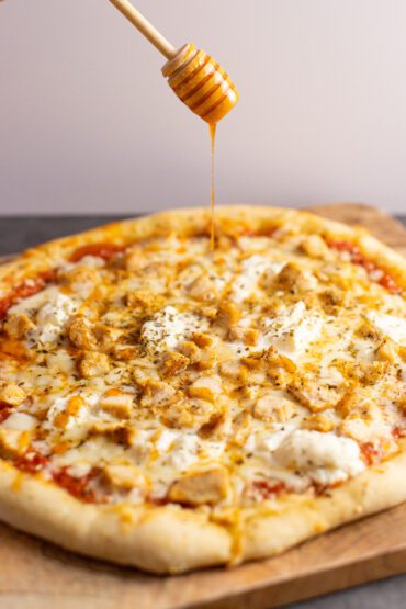 hot honey drizzled onto chicken pizza