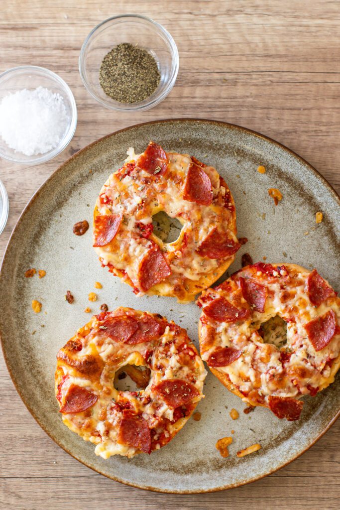 pepperoni pizza bagels on a plate