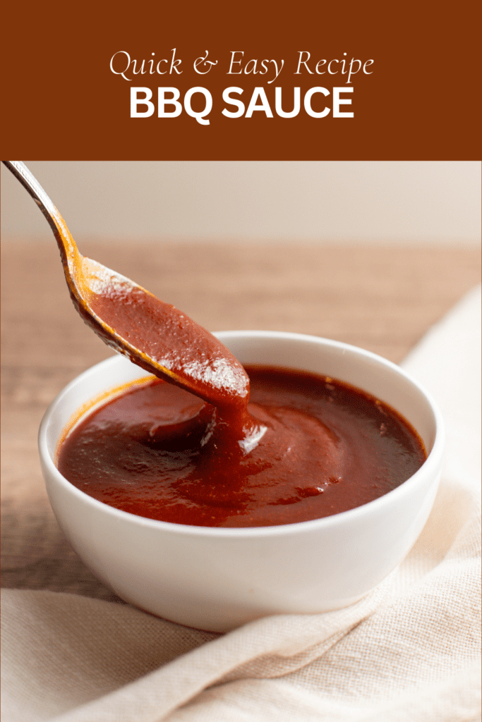 photo of a spoon dipping in a bowl of bbq sauce