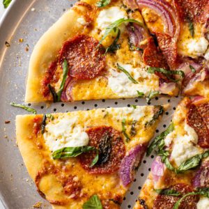 pepperoni basil ricotta pizza on a pizza pan