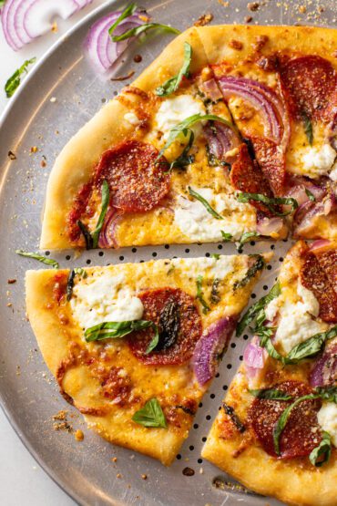 pepperoni basil ricotta pizza on a pizza pan