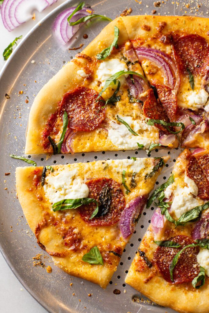 pepperoni basil ricotta pizza on a pizza pan