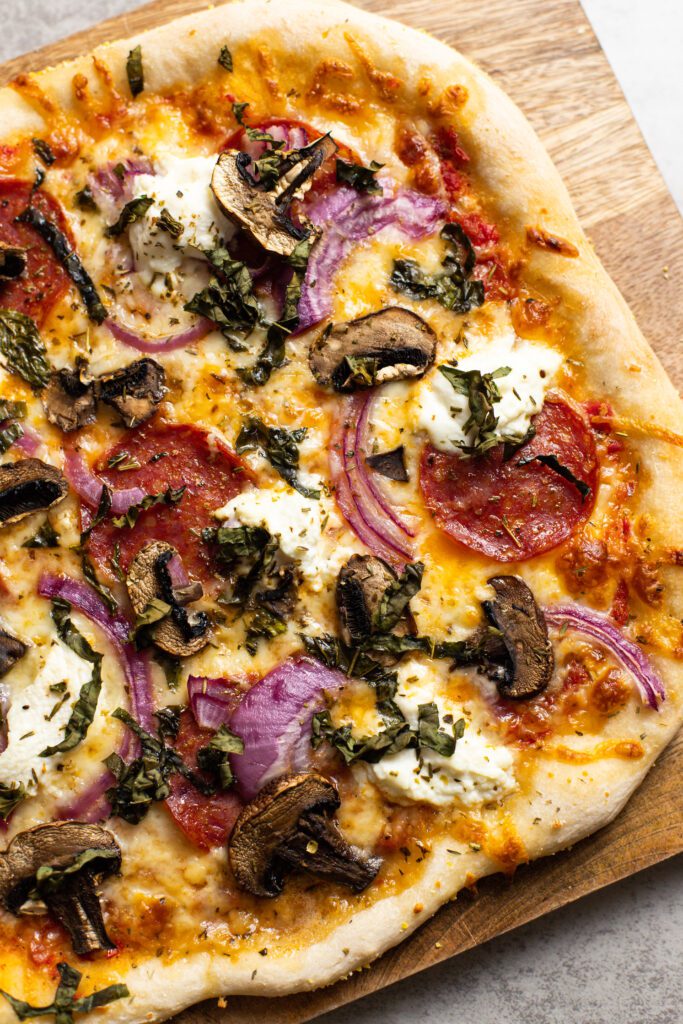 pepperoni mushroom pizza on a cutting board