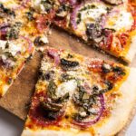 photo of pepperoni mushroom pizza recipe with pizza on cutting board