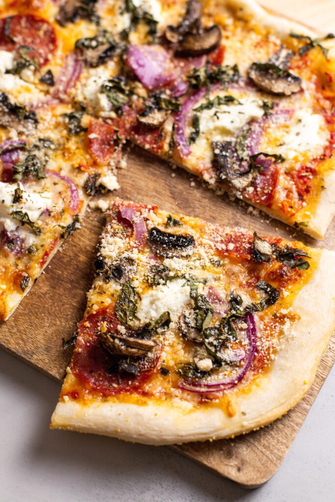 photo of pepperoni mushroom pizza recipe with pizza on cutting board