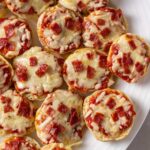 pizza bagel bites sitting on a plate