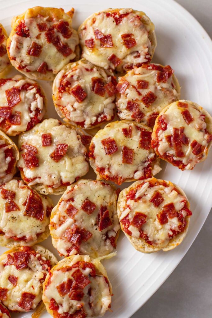 pizza bagel bites sitting on a plate