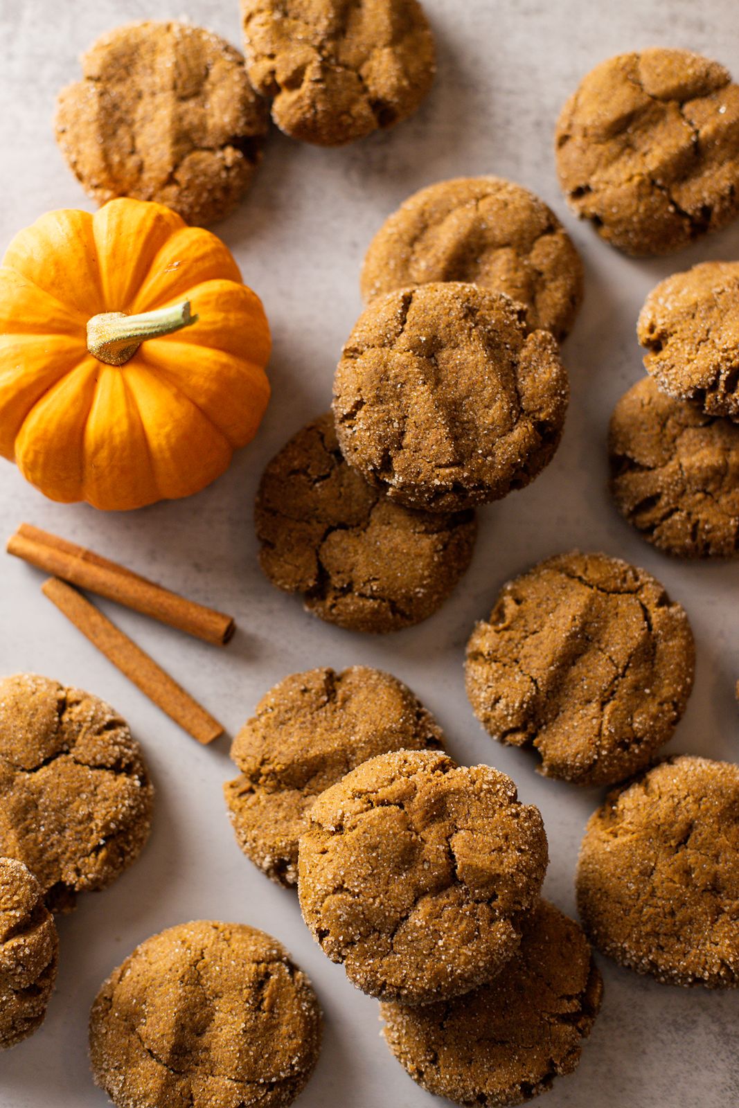 pumpkin molasses cookies on a baking sheet with a pumpkin