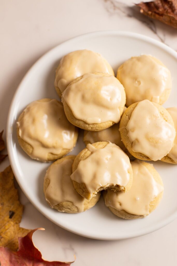 soft maple cookies iced with maple syrup glaze on plate