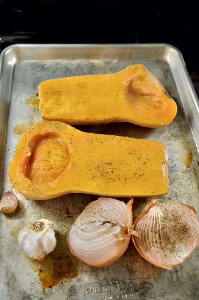 Squash, onion, and garlic roasted for roasted butternut squash soup with onion and garlic​