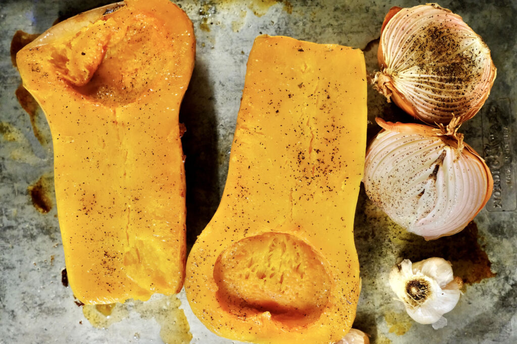 Squash, onion, and garlic roasted for roasted butternut squash soup with onion and garlic​