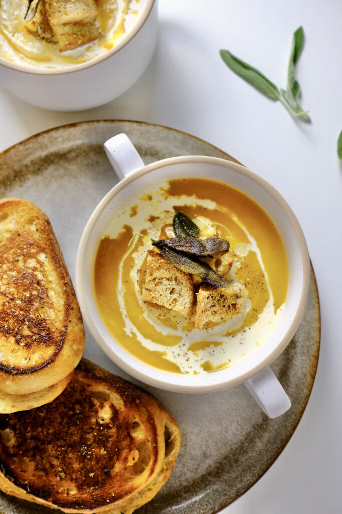 butternut squash soup with roasted garlic​ in a bowl