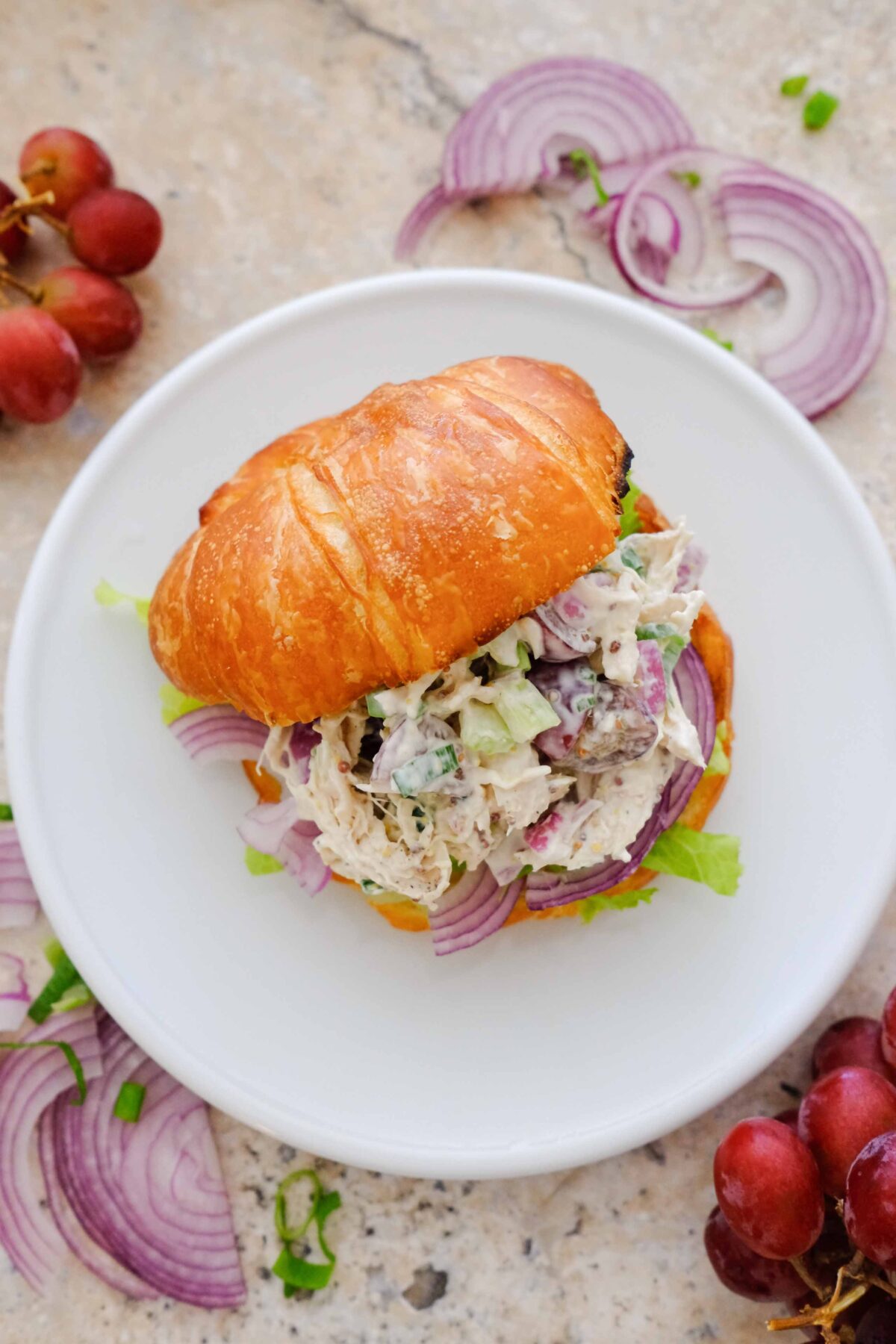chicken salad sandwich recipe with grapes on a plate