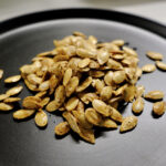 seeds on a plate showing how to roast butternut squash seeds