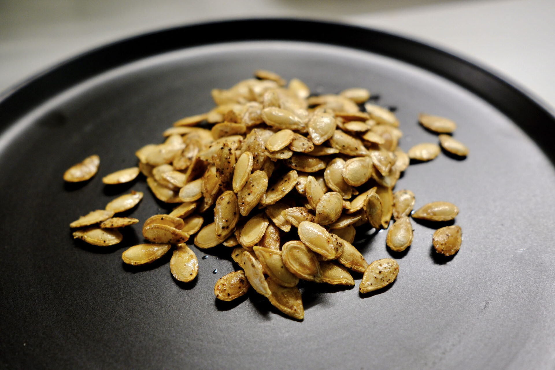 seeds on a plate showing how to roast butternut squash seeds