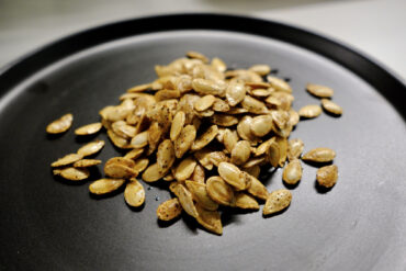 seeds on a plate showing how to roast butternut squash seeds