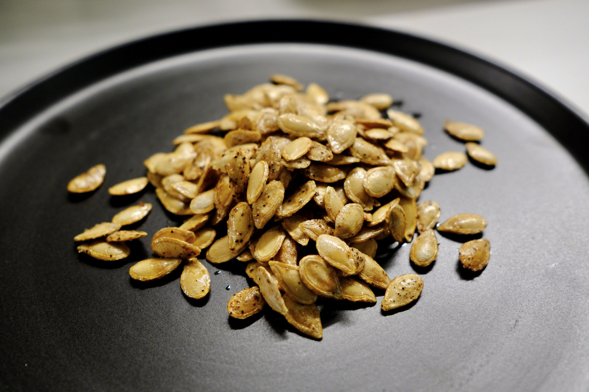 seeds on a plate showing how to roast butternut squash seeds