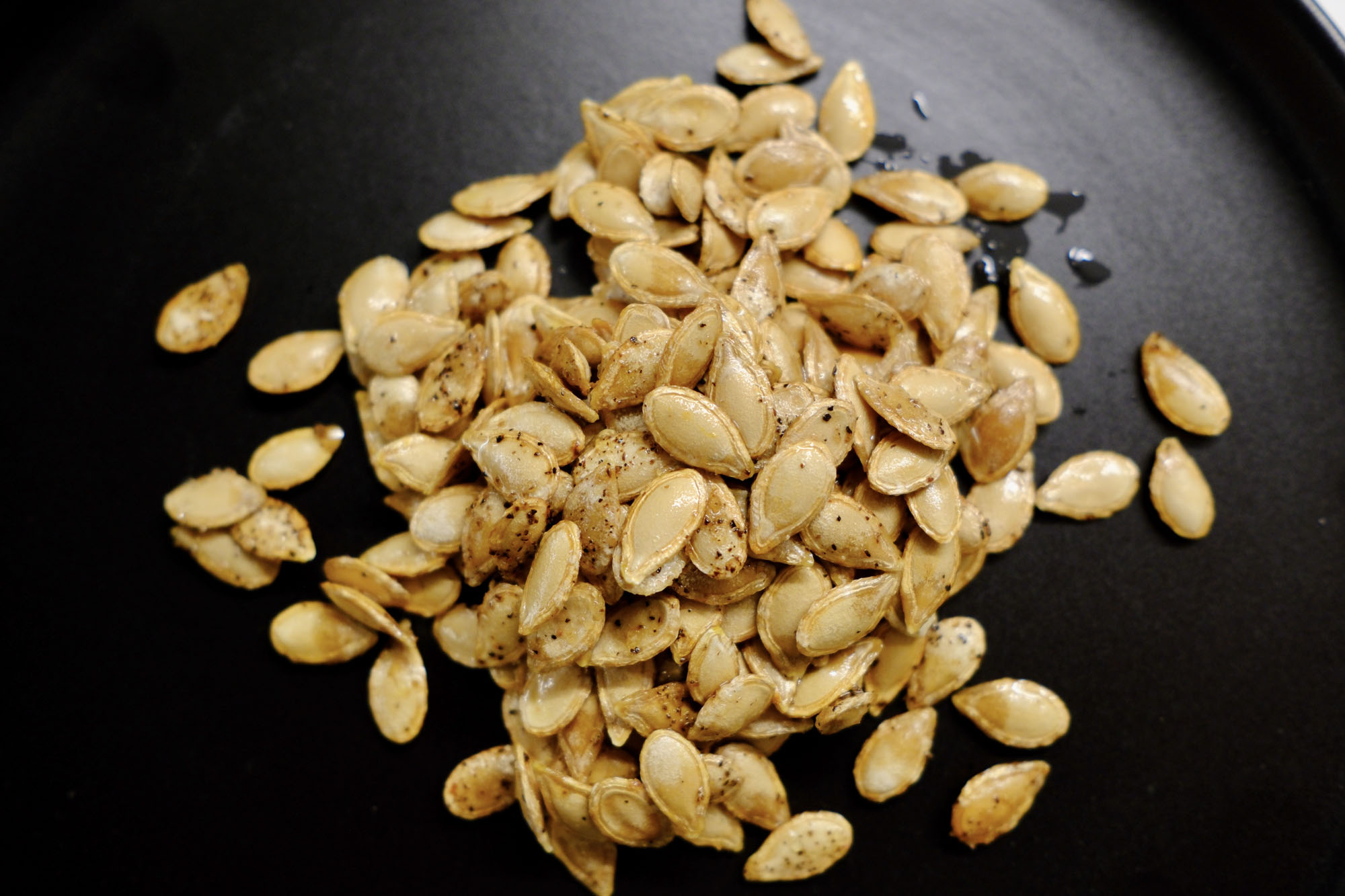 seeds on a plate showing how to roast butternut squash seeds