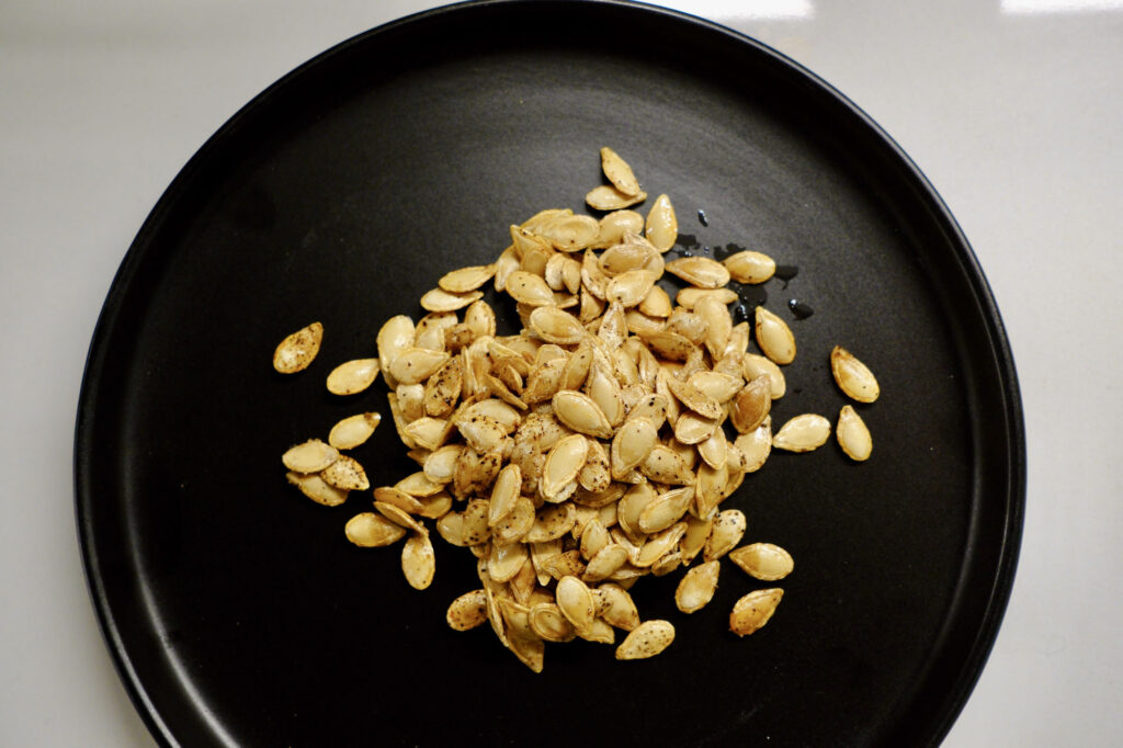 roasted butternut squash seeds on a plate