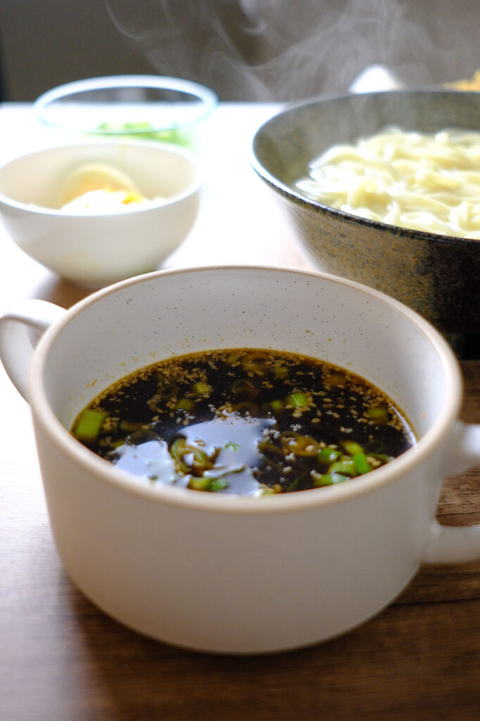 Bowl of hot kamaage udon with dipping sauce on the side – kamaage udon recipe Marugame-style