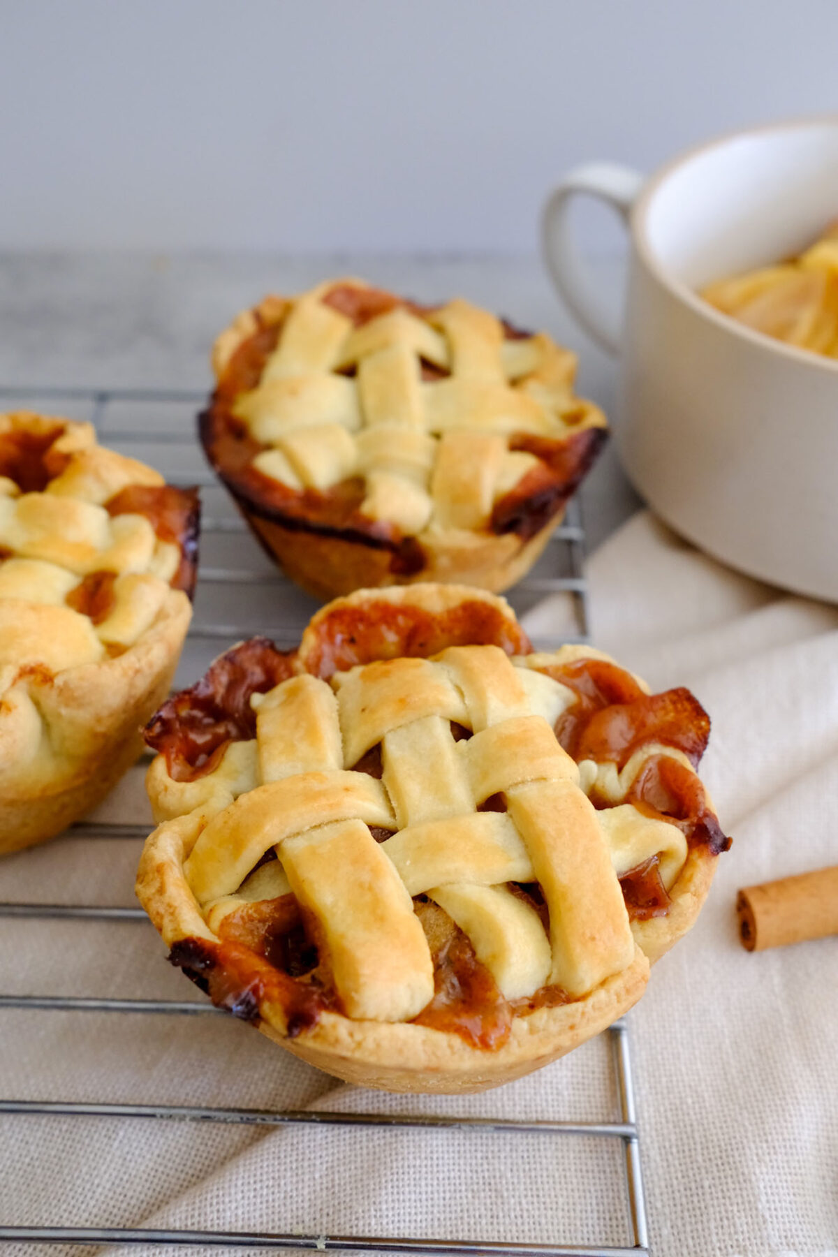 little pies sitting on baking tray, made from Fresh Cup of Joy's mini apple pie recipe.