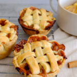 little pies sitting on baking tray, made from Fresh Cup of Joy's mini apple pie recipe.