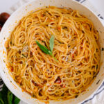 roasted garlic tomato pasta in a pan on a napkin