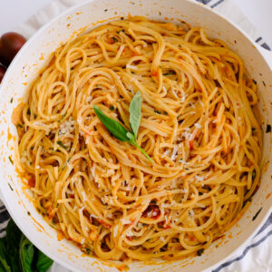 roasted garlic tomato pasta in a pan on a napkin