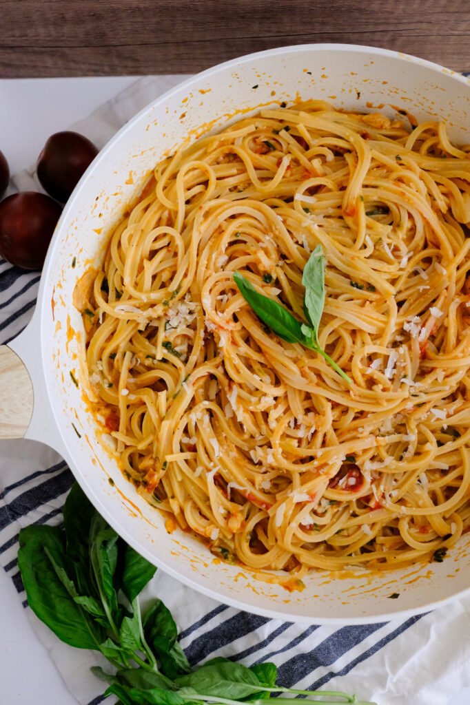 roasted garlic pasta​ with tomatoes in a pan