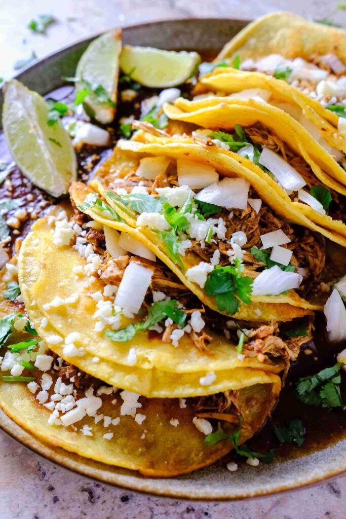 chicken birria tacos slow cooker​ on a plate