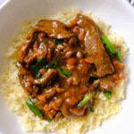 mongolian beef slow cooked​ in a bowl
