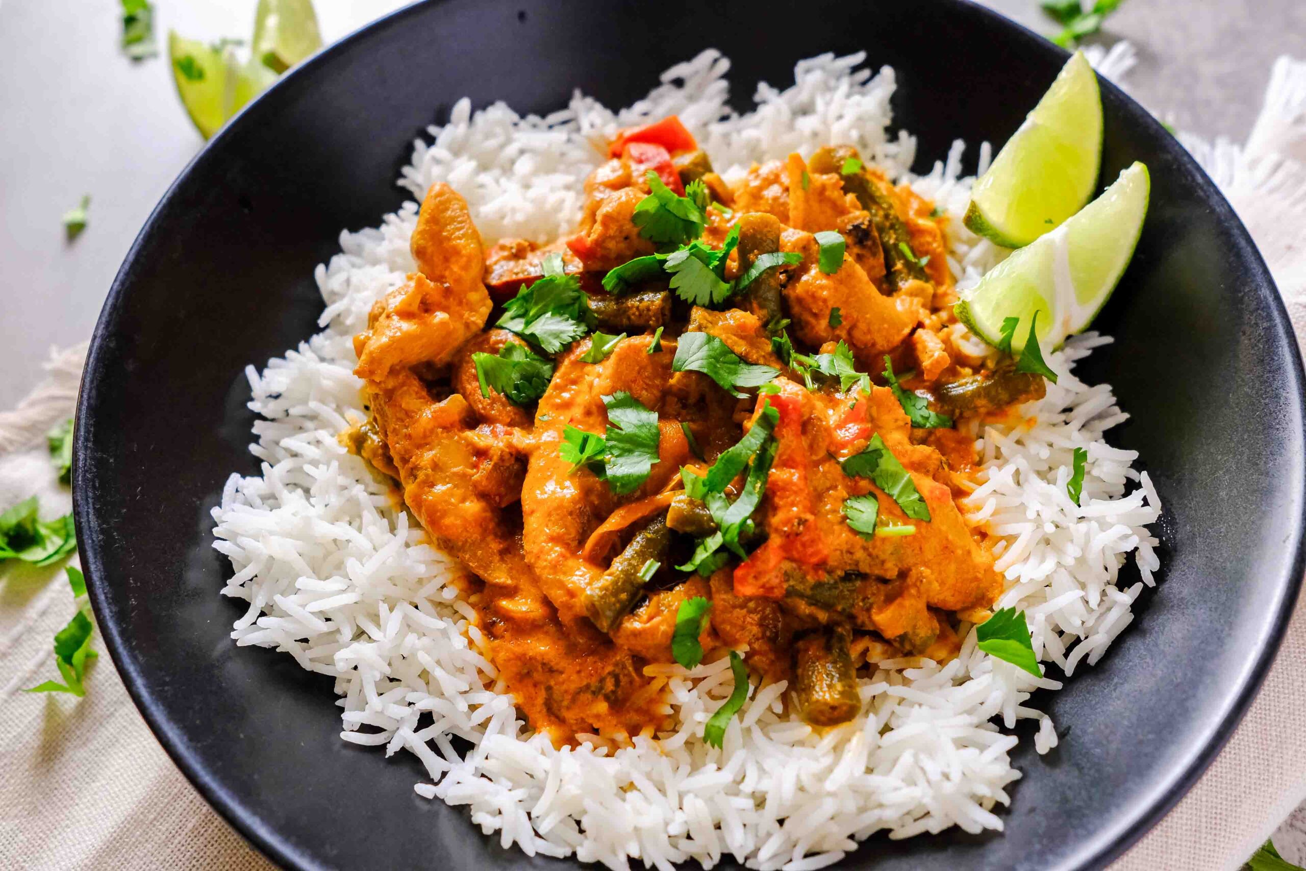 red chicken curry slow cooker in a black bowl
