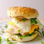 bagel sandwich breakfast on a plate with microgreens