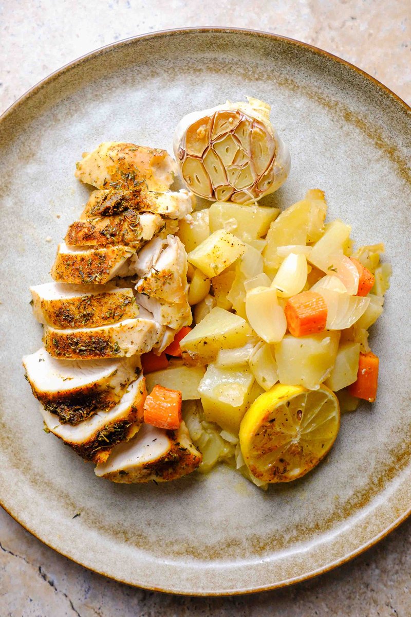 plate full of dutch oven chicken breast and vegetables