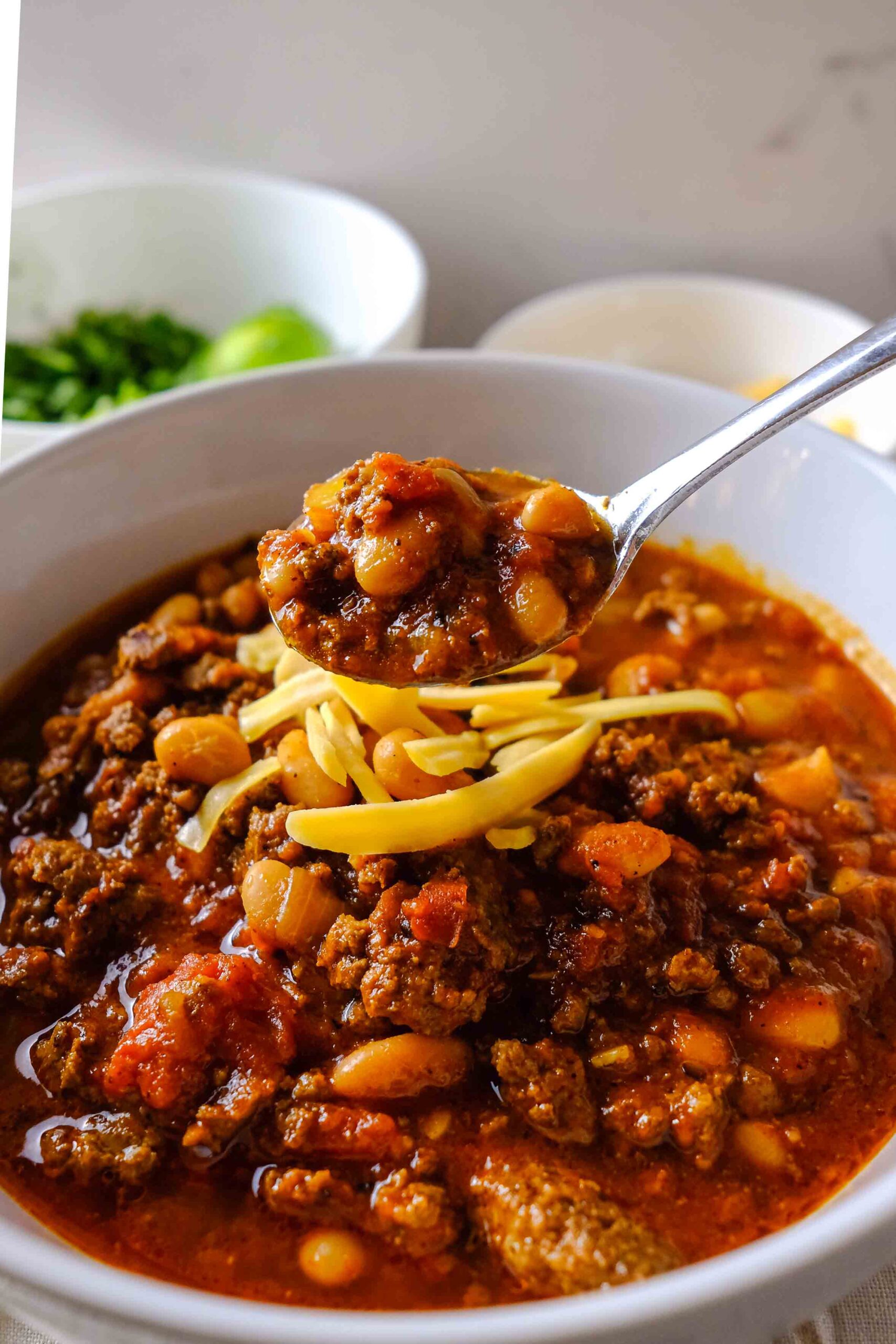 easy crockpot chili recipe​ in a bowl and spoon