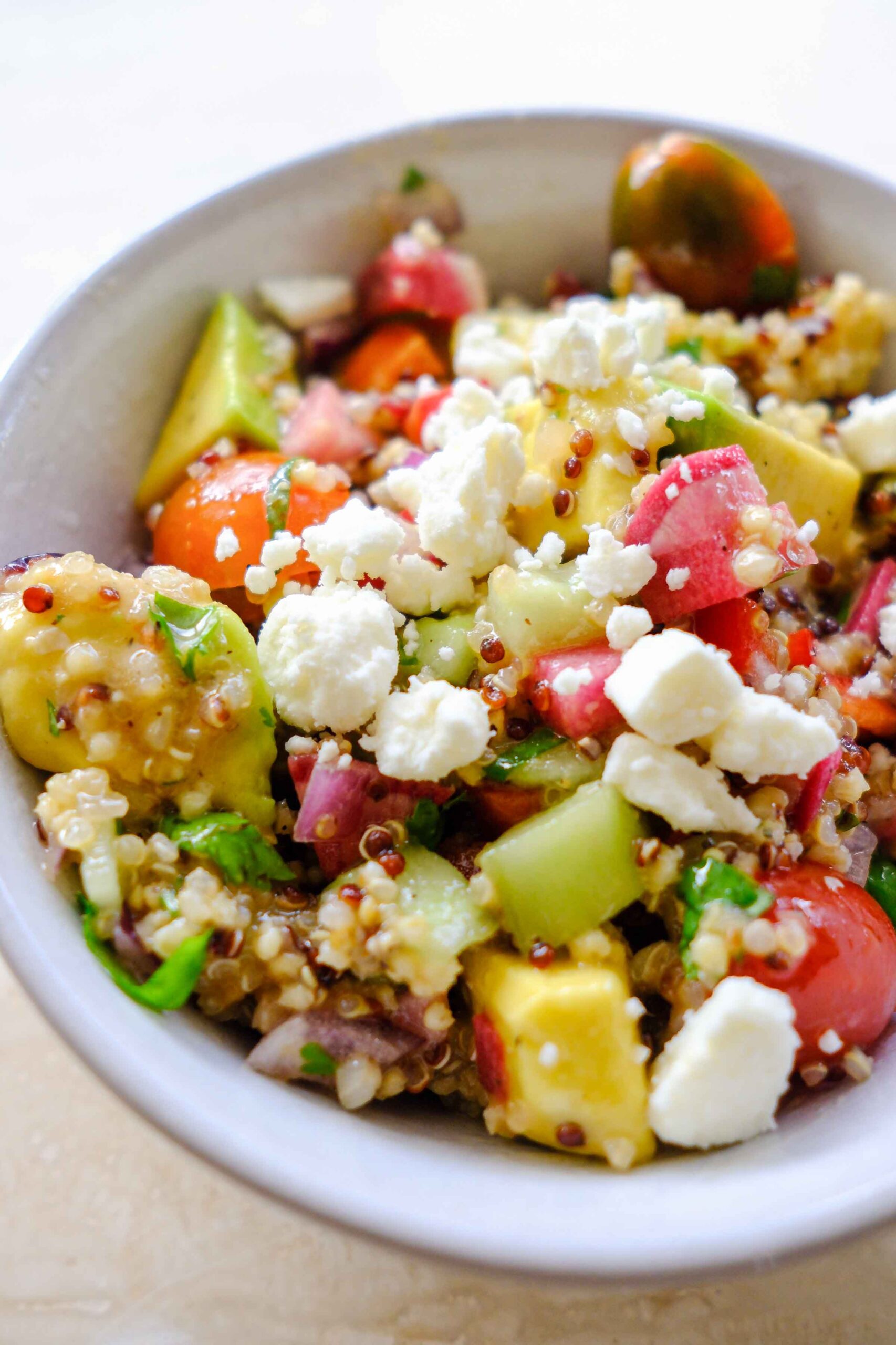 quinoa cucumber tomato salad with rainbow colors