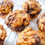 cottage cheese cinnamon roll muffin​ on a wire rack