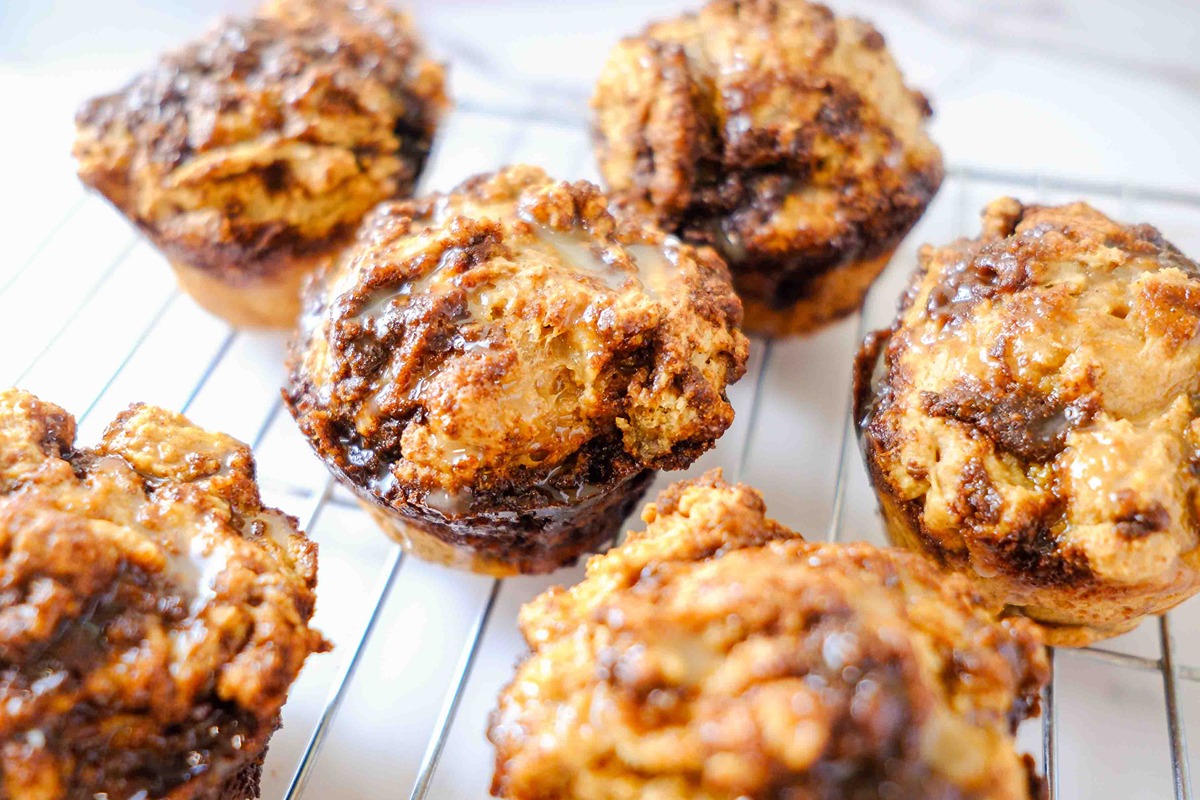 cottage cheese cinnamon roll muffin​ on a wire rack