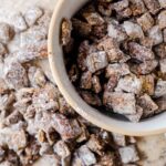 muddy buddy recipe, also known as puppy chow, spilling over a bowl