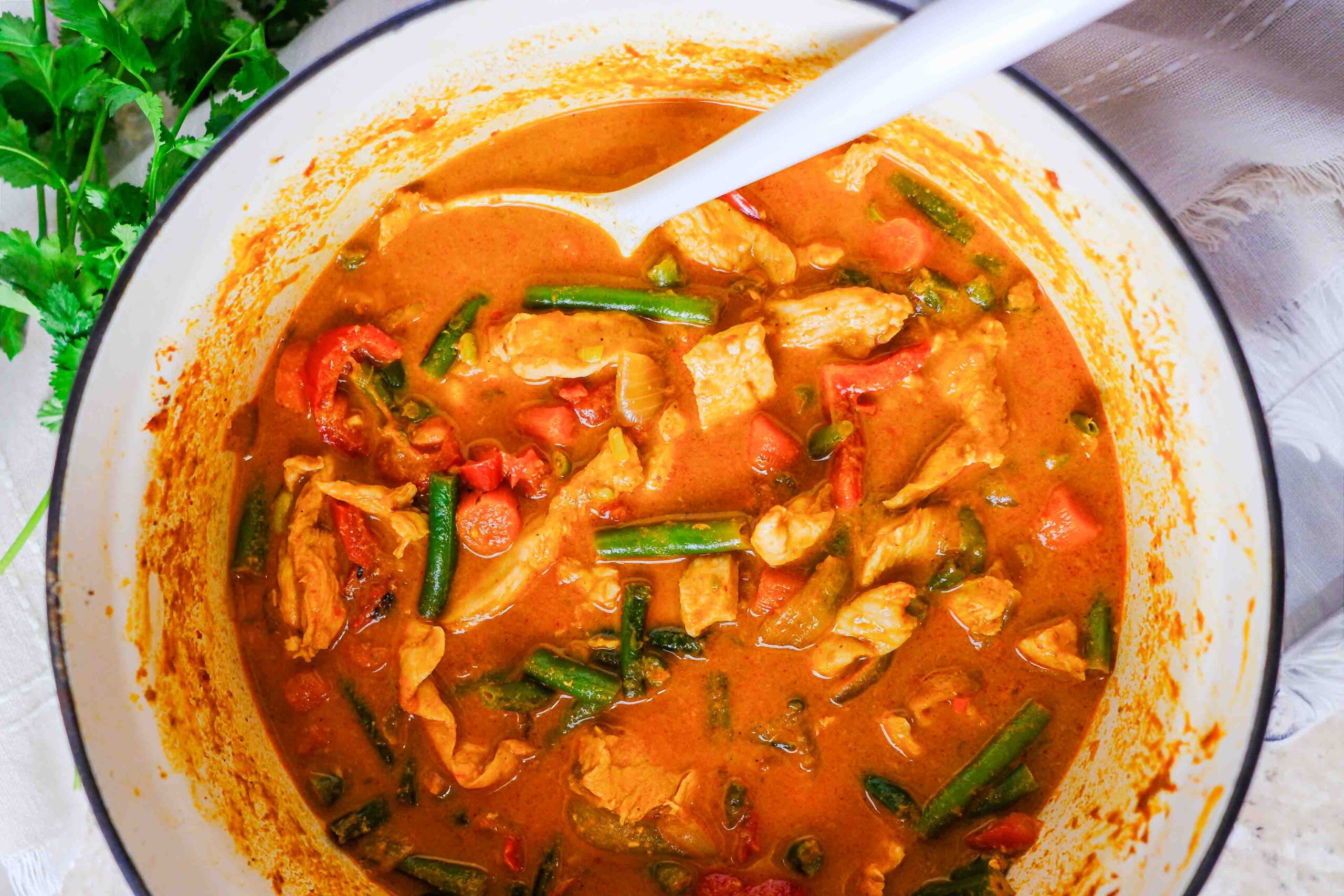 thai red chicken curry with rice and cilantro
