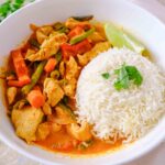 red thai chicken curry with rice and cilantro