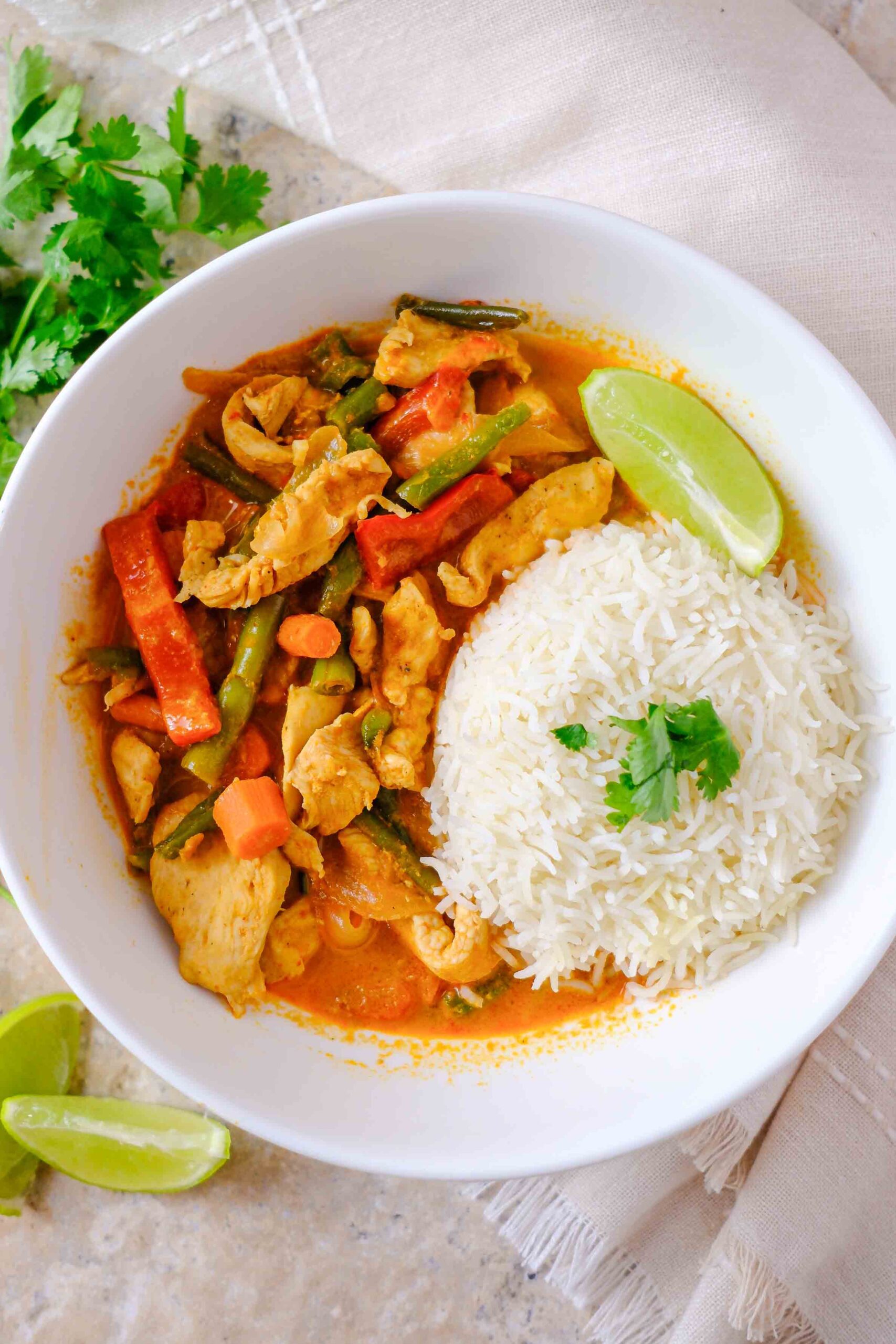 red thai chicken curry with rice and cilantro