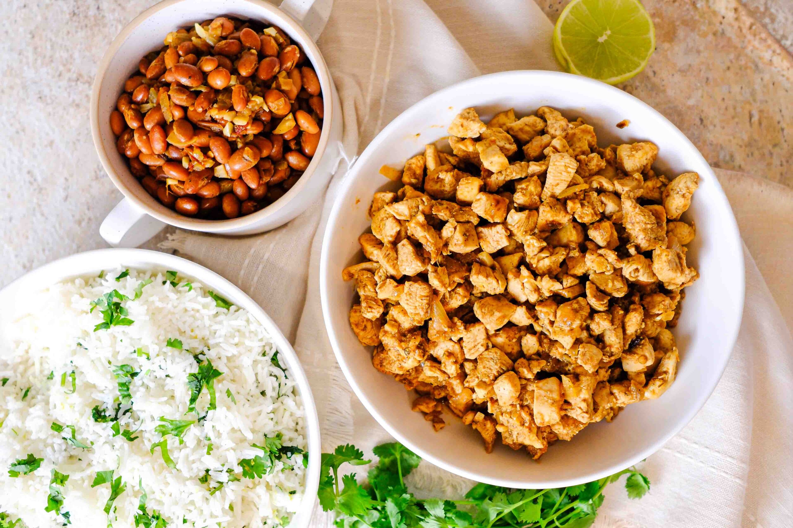 bowl of chipotle chicken with fixings for a burrito